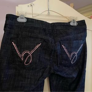 Dark denim Bebe jeans with pink rhinestone B’s on the back